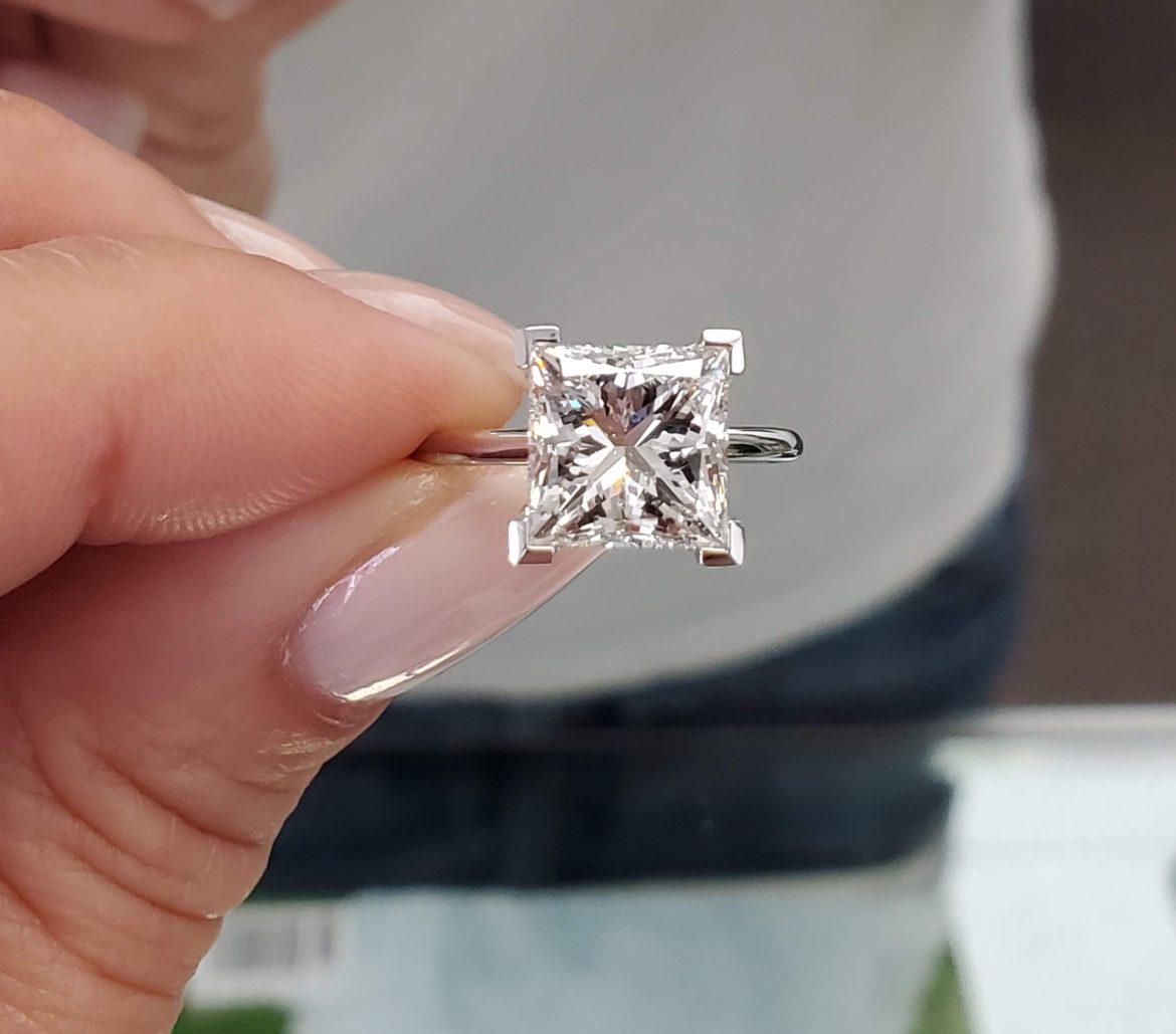 Simple and refined -- A dainty solitaire engagement ring in white gold.